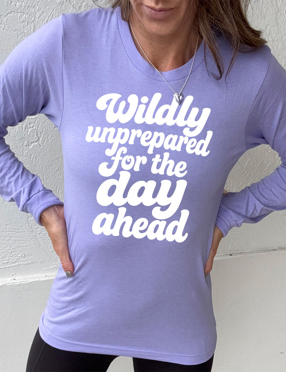 heather dark lavender long sleeve tee with words on it saying "Wildly unprepared for the day ahead"