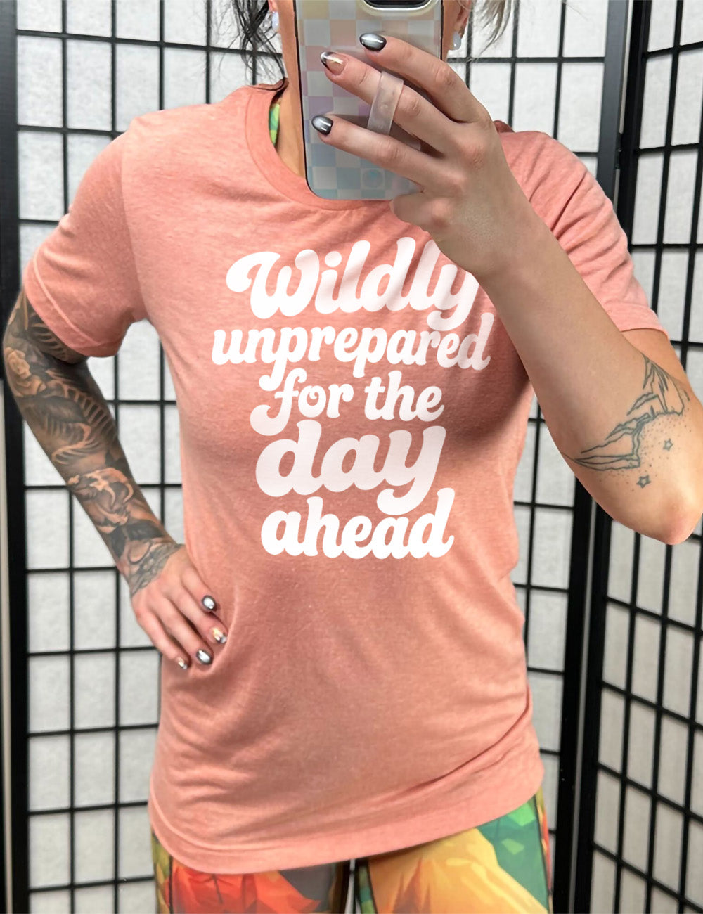sunset unisex tee with words on it saying "Wildly unprepared for the day ahead"