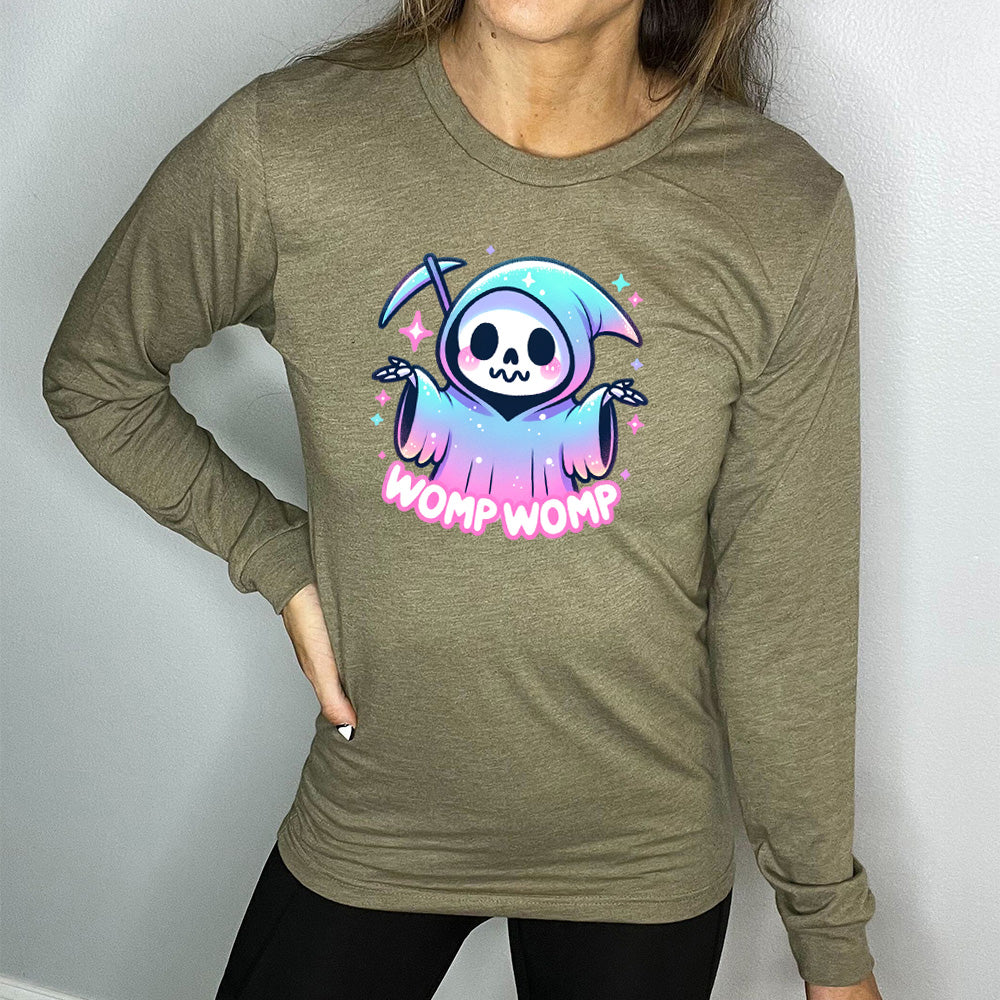 heather olive long sleeve shirt with the text "Womp Womp" on it, with the cartoon graphic of a sparkly-robed grim reaper, skeletal hands raised in question, surrounded by sparkly little stars