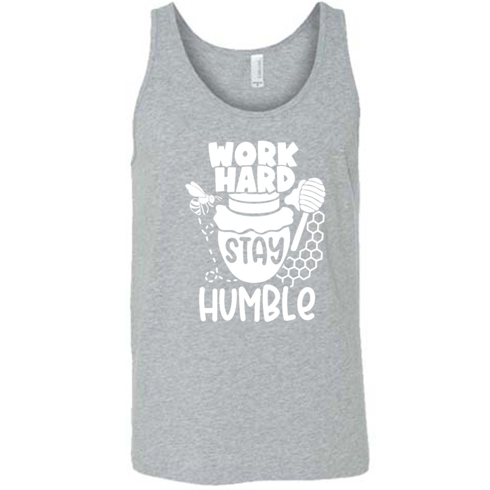 grey unisex tank with the words "work hard stay humble" on it, with the word "stay" on the graphic of a honeypot, and a bee flying around the pot's left, and some honeycomb and a honey spoon on its right