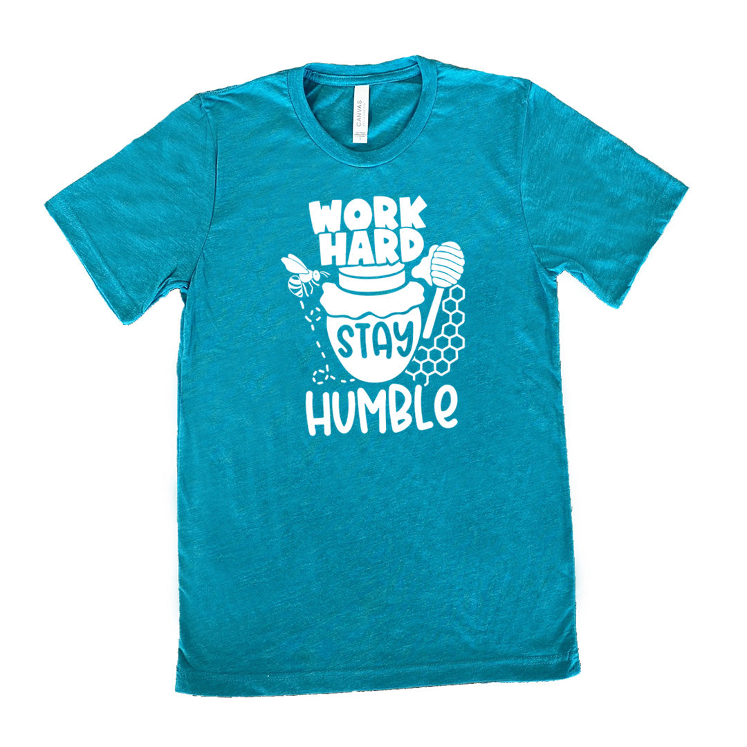 teal unisex tee with the words "work hard stay humble" on it, with the word "stay" on the graphic of a honeypot, and a bee flying around the pot's left, and some honeycomb and a honey spoon on its right