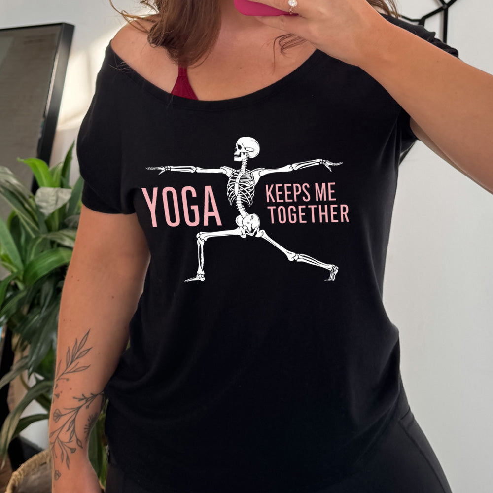black slouchy tee with the words "yoga keeps me together" with graphic of a skeleton doing the warrior pose