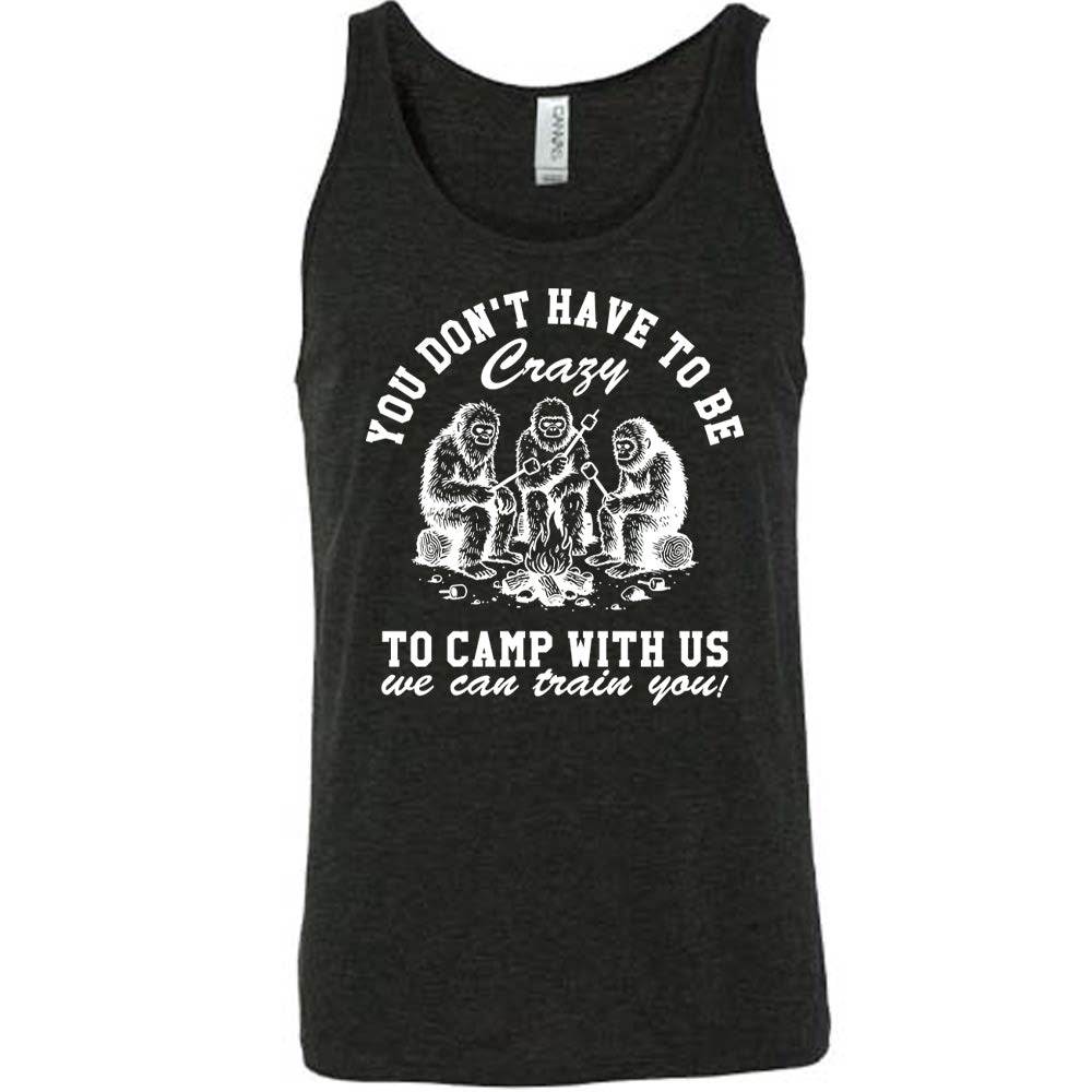 black unisex tank with the words "you don't have to be crazy to camp with us we can train you!" on it with the graphic of three sasquatches toasting marshmallows over a campfire