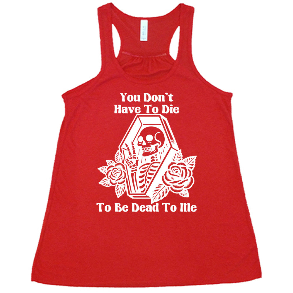 red flowy tank with the words "You don't have to die to be dead to me" on it with the graphic of a a skeleton in a coffin, giving the peace sign, with two flowers on either side of the coffin