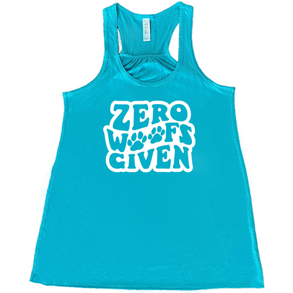 Teal colored flowy tank with paw print graphic on it that says "Zero Woofs Given"