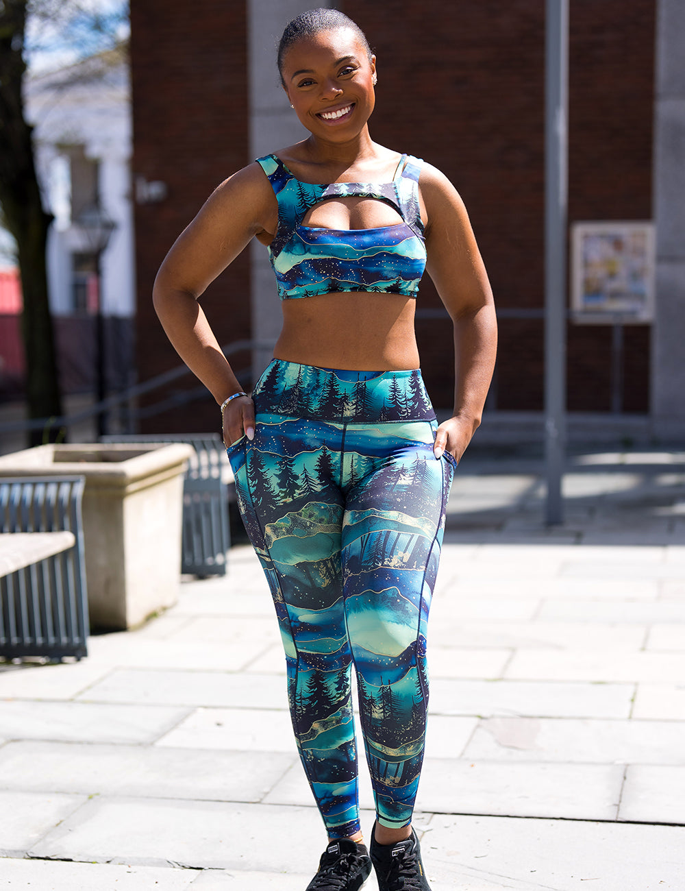 model wearing the aurora forest leggings and bra outside