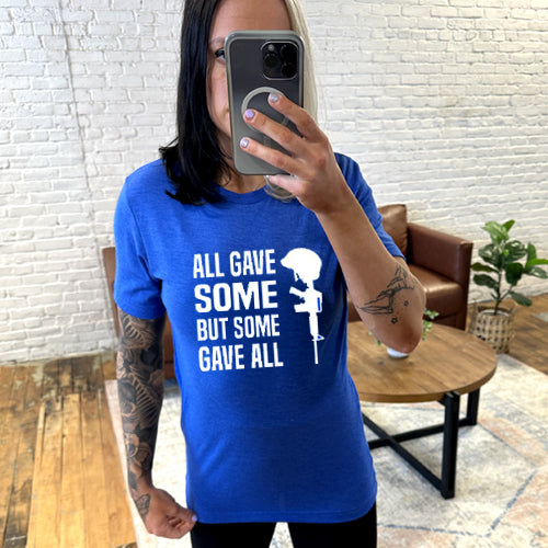 model wearing blue unisex shirt with the saying "all gave some but some gave all" in white