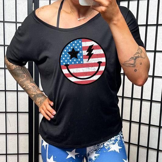black slouchy tee with an american flag smiley face on it.