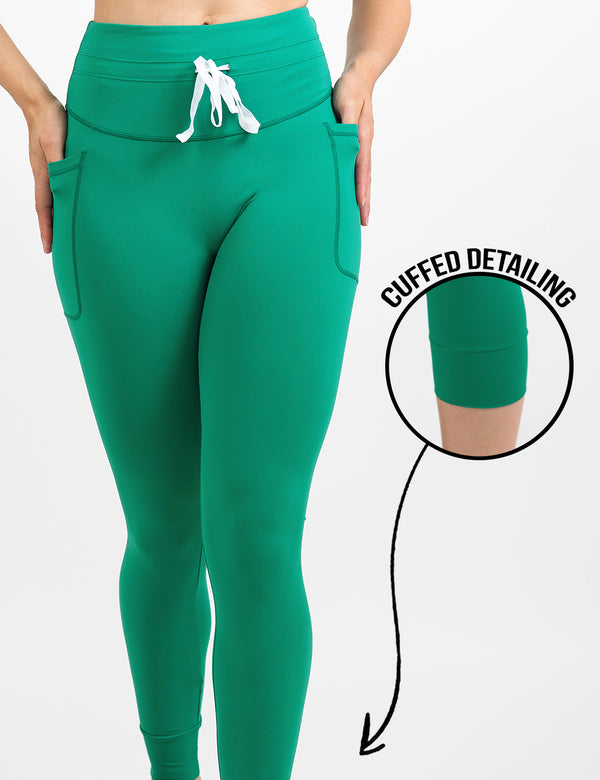 front of the aqua green omni style leggings with a white drawstring against a white background, including a close up of the cuffed detailing