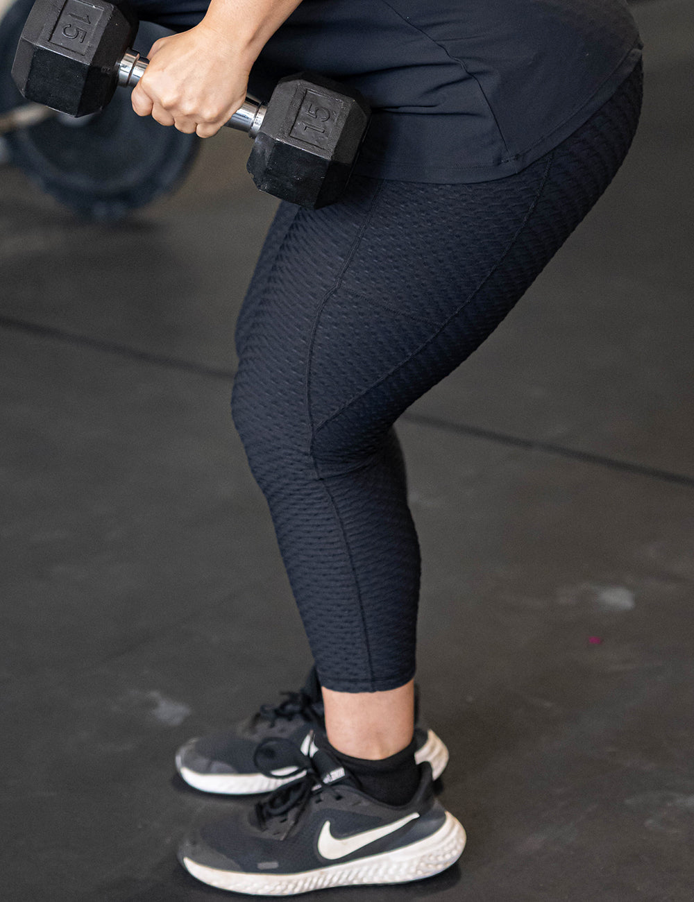 model wearing the capri black waffle textured leggings in the gym