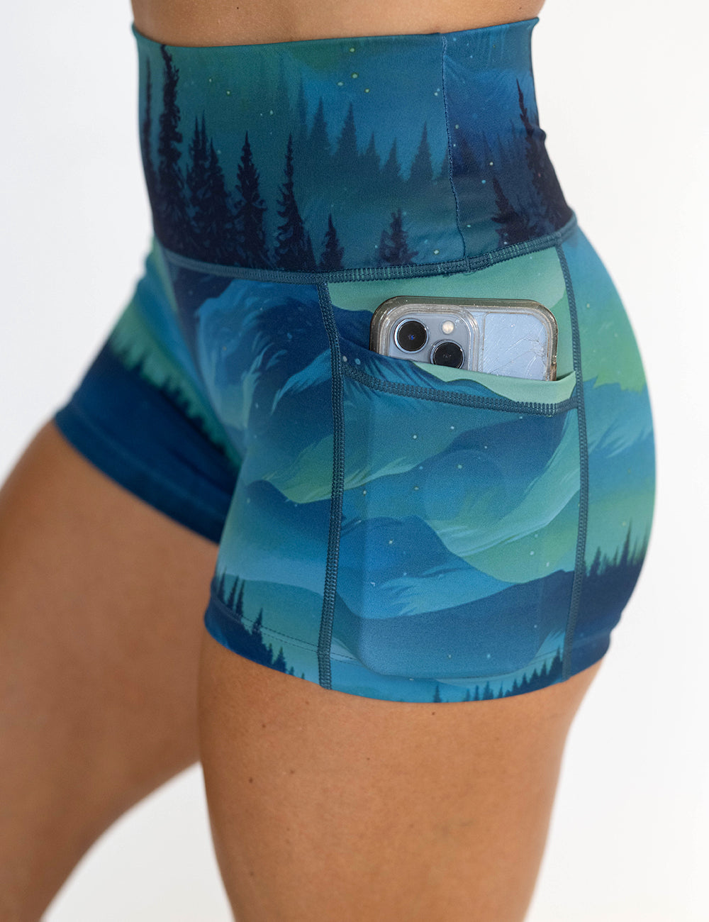 close up of the 2.5 inch wilderness aurora shorts with a phone in the pocket