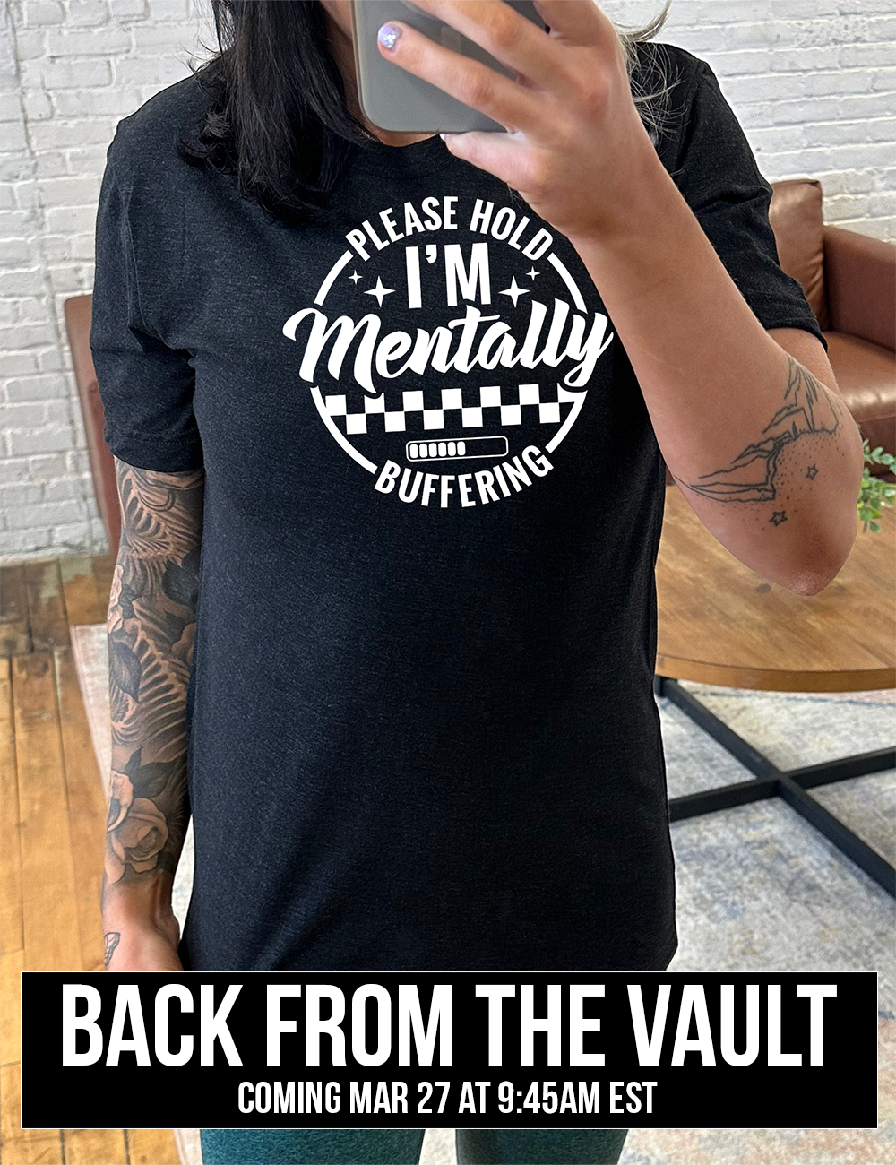 black unisex tee with the words "please hold I'm mentally buffering" written on it in a circle graphic, with some of the words part of the arches, and within the circle there are two layers of checkerboard as well as a buffering bar, which is about 6 out of 10 full, coming soon