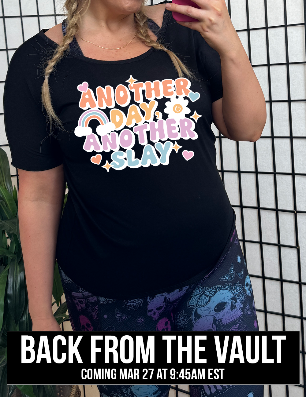 black slouchy tee with the words "another day, another slay" on it, with little graphics of stars, hearts, a sun, and a rainbow, coming soon