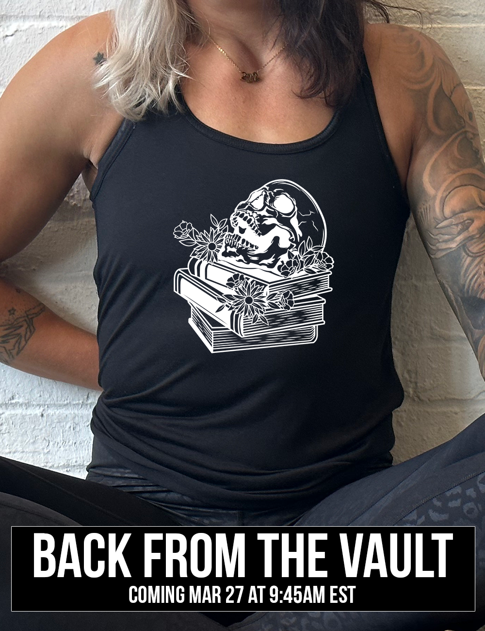 black muscle tank with the graphic of an open-mouthed skull atop a stack of books, with flowers, coming soon