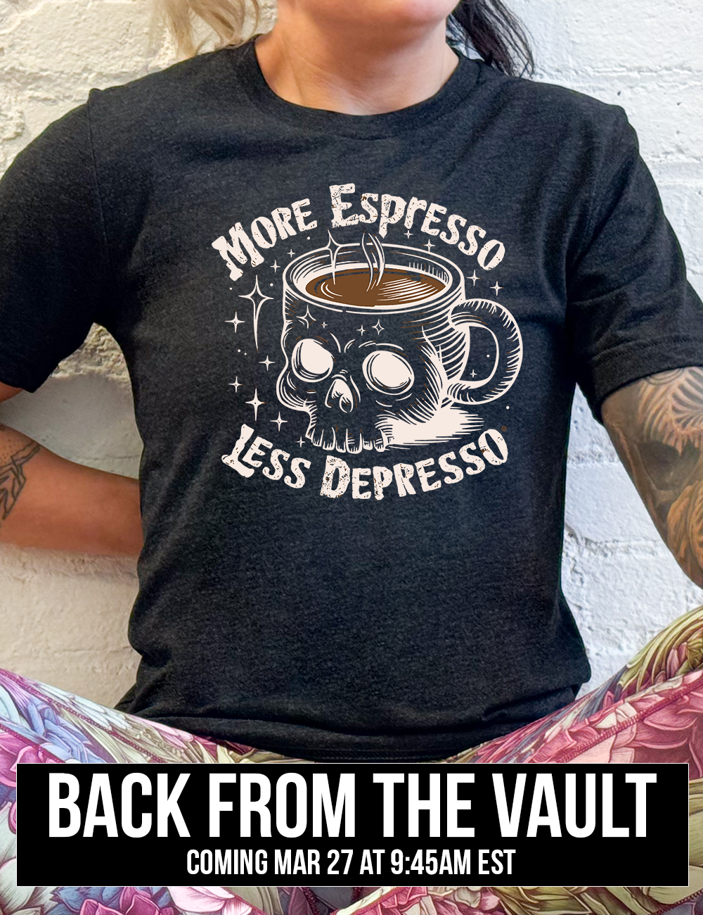 black unisex tee with the words "more espresso less depresso on it, around the graphic of a skull-shaped mug full of a steaming beverage, with lots of little stars around, coming soon