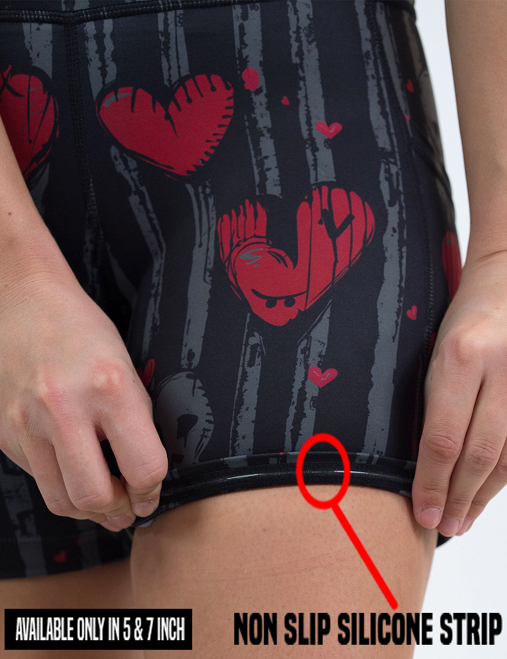 close up of the red hearts against stripes shorts getting rolled up to show the non slip silicone strips found in only the 5 and 7 inch shorts