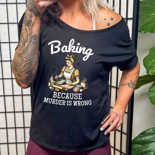 model wearing a black slouchy tee with the saying "Baking Because Murder Is Wrong" on it