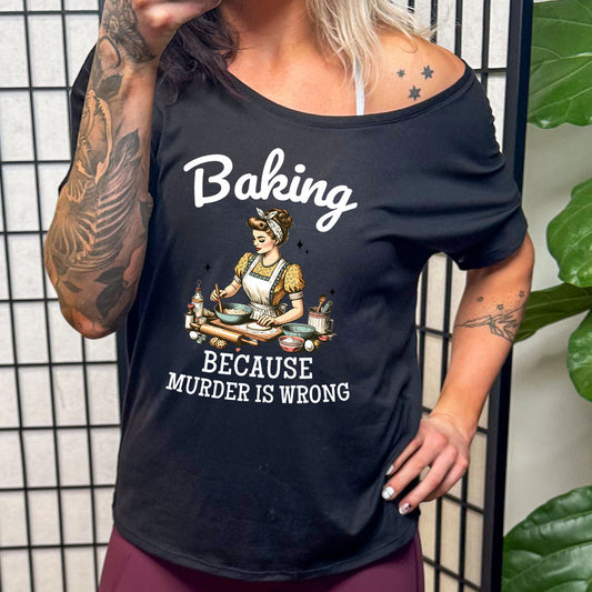 model wearing a black slouchy tee with the saying "Baking Because Murder Is Wrong" on it
