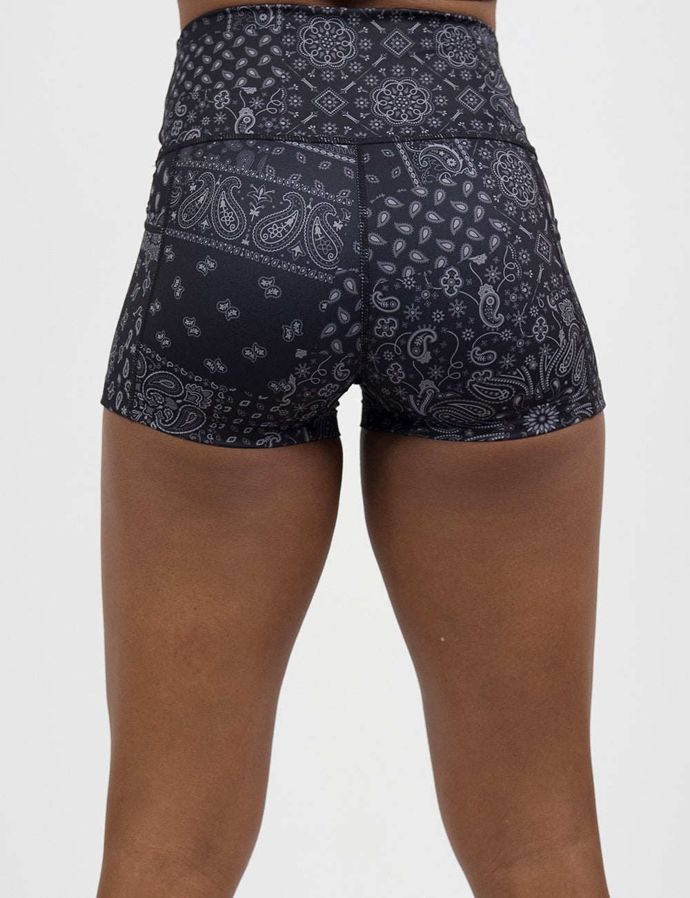 back of the 2.5 inch black shorts with a white paisley pattern against a white background