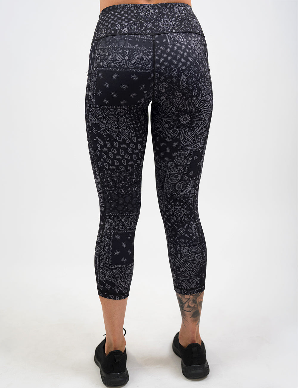 back of the capri black paisley patterned leggings against a white background