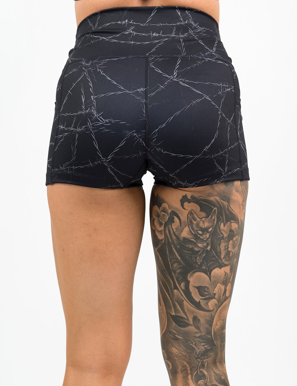back of the 2.5 inch black shorts with a white barbed wire pattern on it against a white background