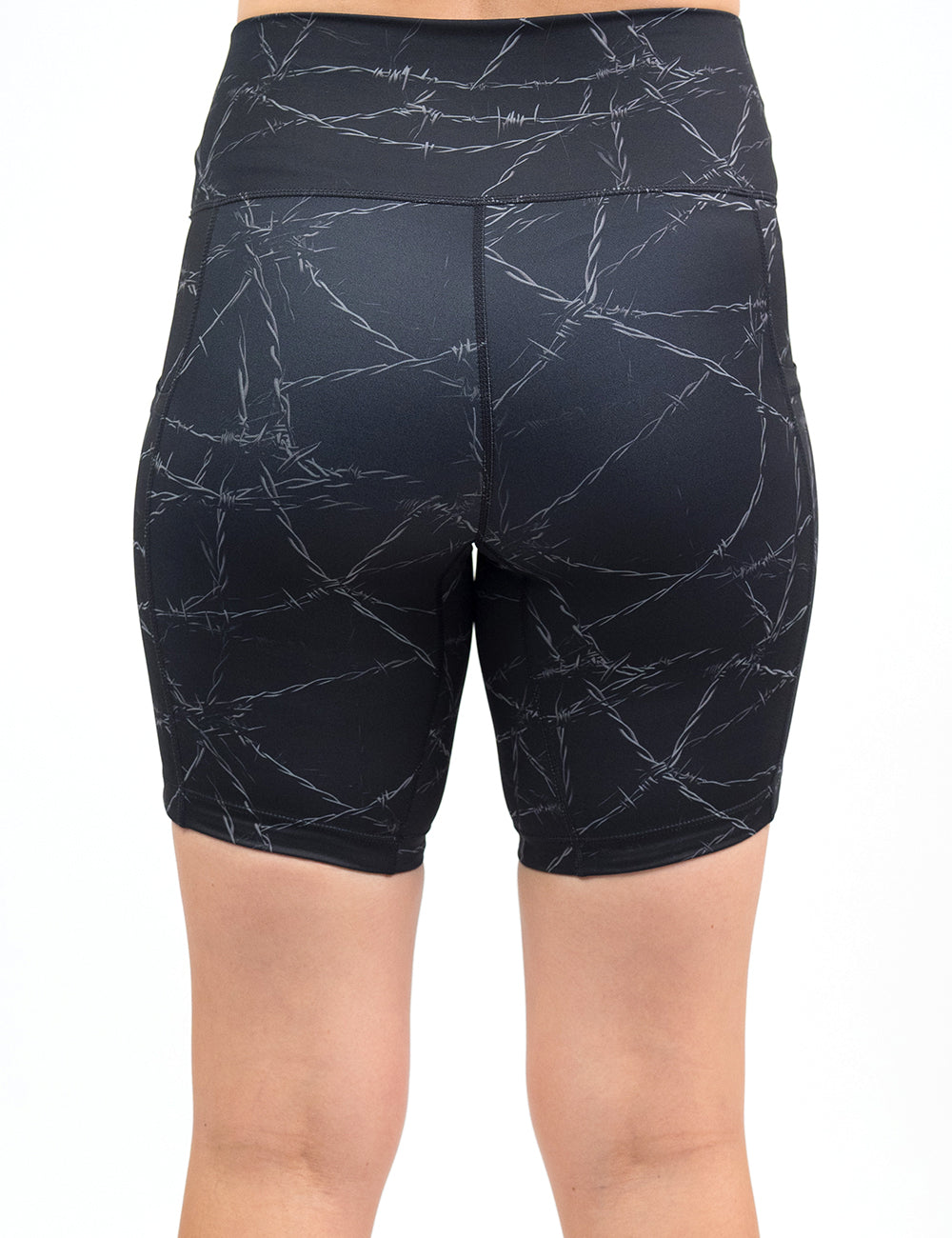 back of the 7 inch black shorts with a white barbed wire pattern on it against a white background