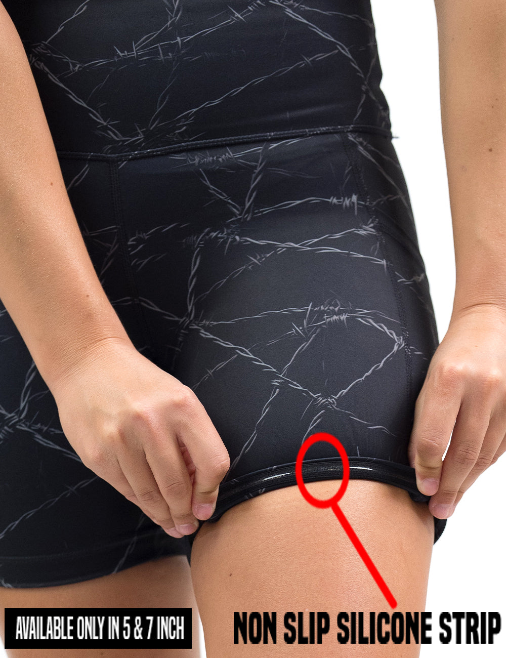 close up of the black shorts with a white barbed wire pattern on it rolled up to show the non slip silicone strip found in the 5 and 7 inch inseam lengths