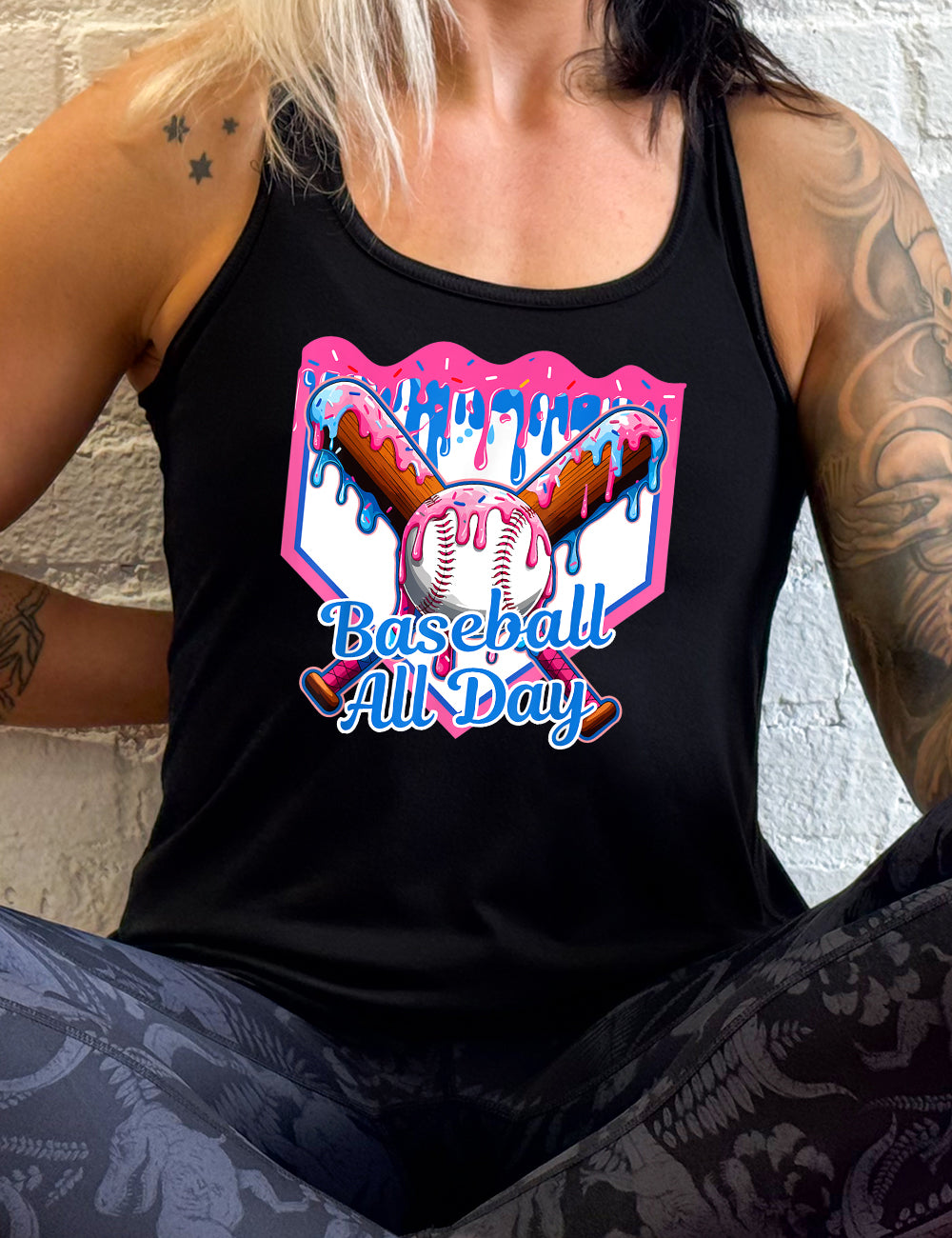 black flowy racerback tank with the graphic of a dripping baseball diamond, with the graphic of a dripping baseball with two dripping baseball bats behind it, and the words "baseball all day" on it