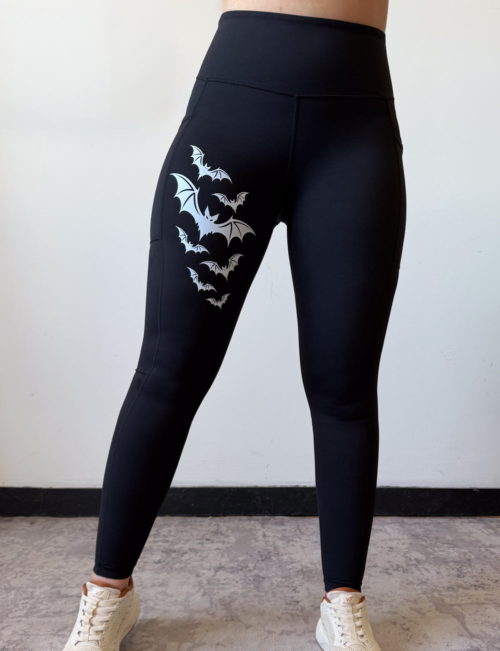 black leggings with 7 bats on the right leg