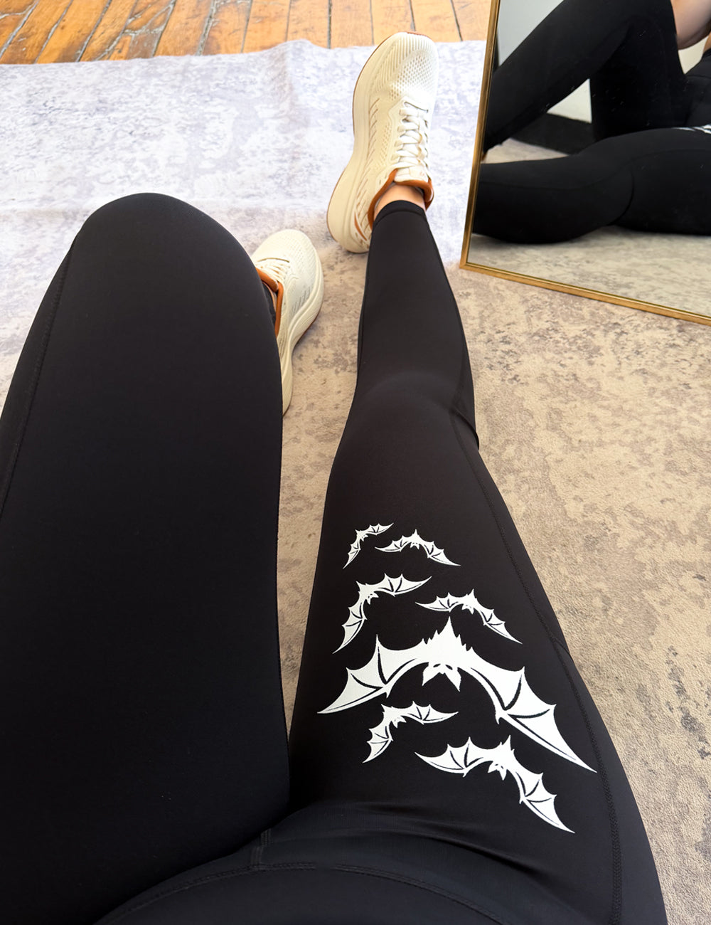 black leggings with 7 bats on the right leg