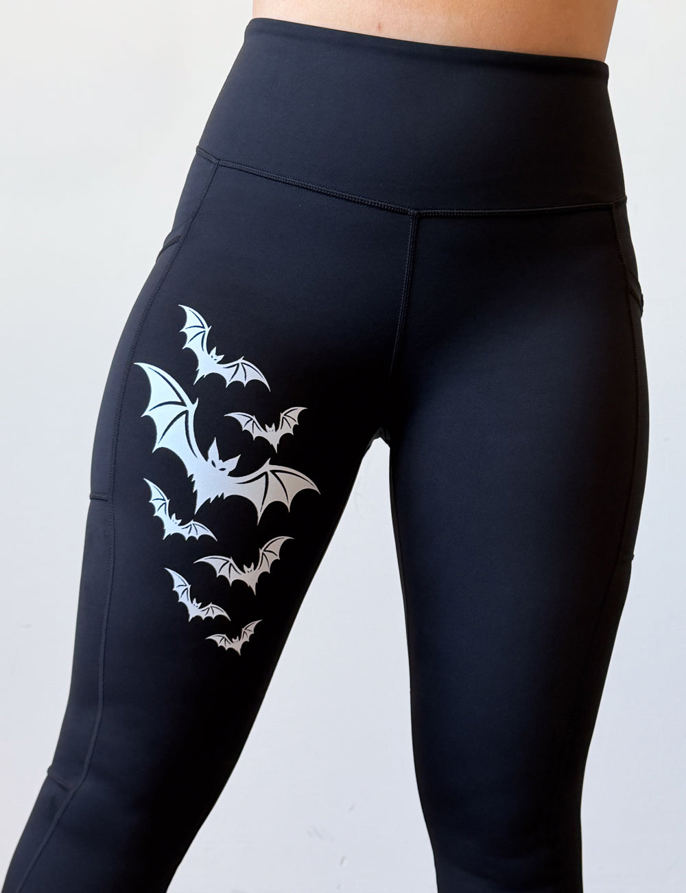 black leggings with 7 bats on the right leg