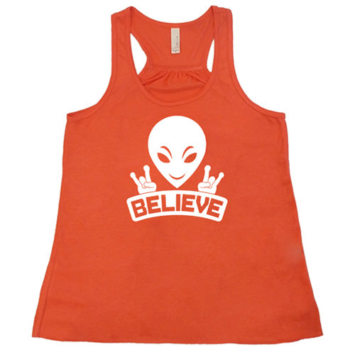 coral racerback tank top that has an alien design on it that says "believe"