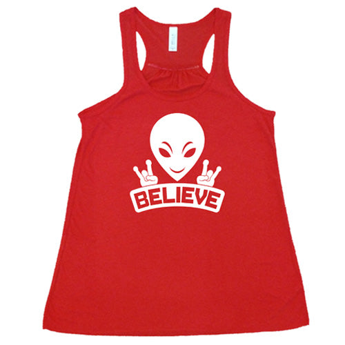 red racerback tank top that has an alien design on it that says "believe"