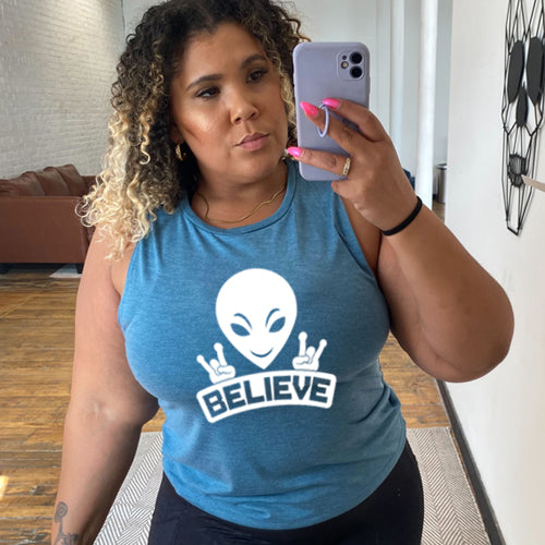 deep teal muscle tank top that has an alien design on it that says "believe"