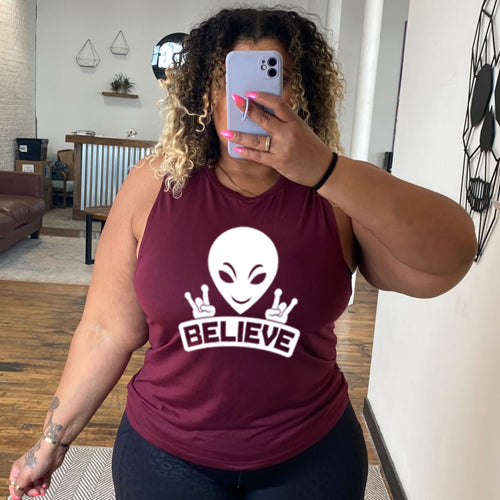 maroon muscle tank top that has an alien design on it that says "believe"