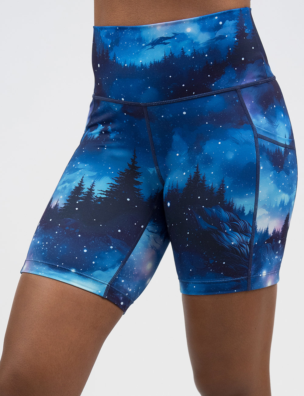 front of the 5 inch blue sky and forest patterned shorts against a white background