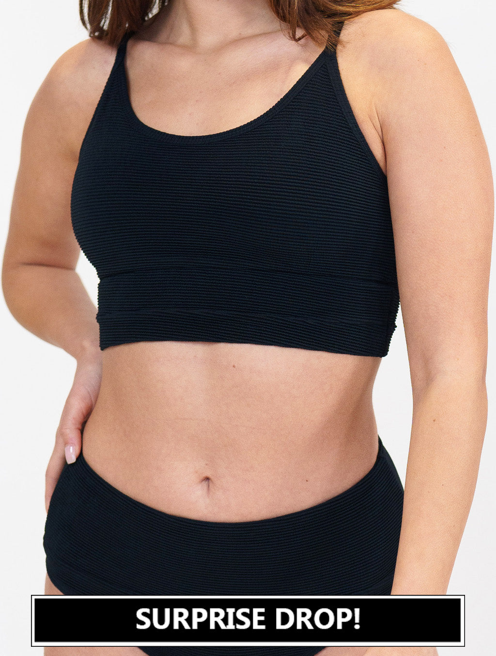 model wearing a black bathing suit