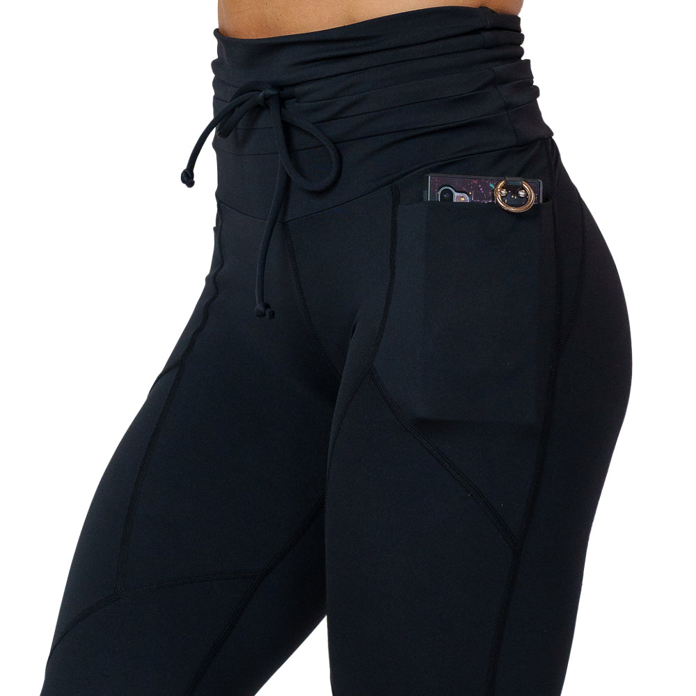 close up of the solid black drawstring leggings against a white background