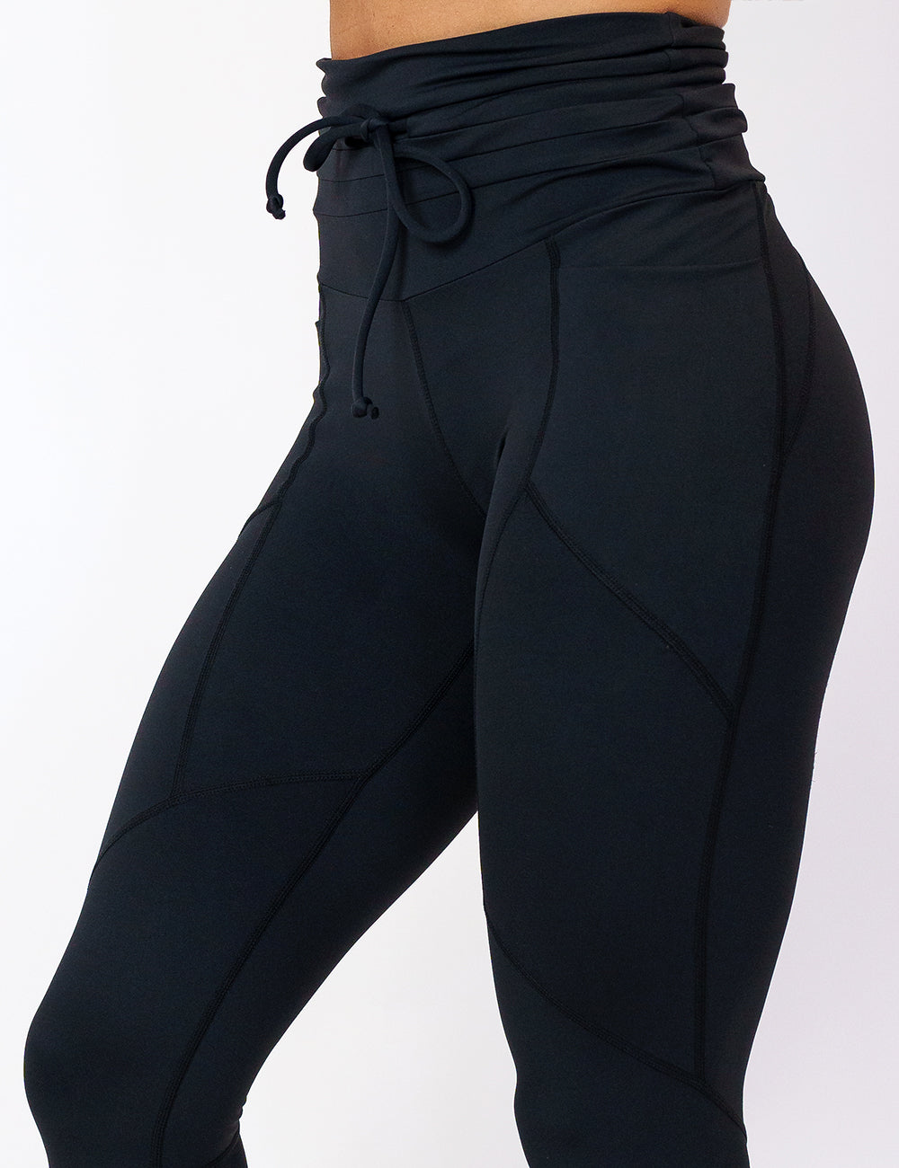 close up of the solid black drawstring leggings against a white background