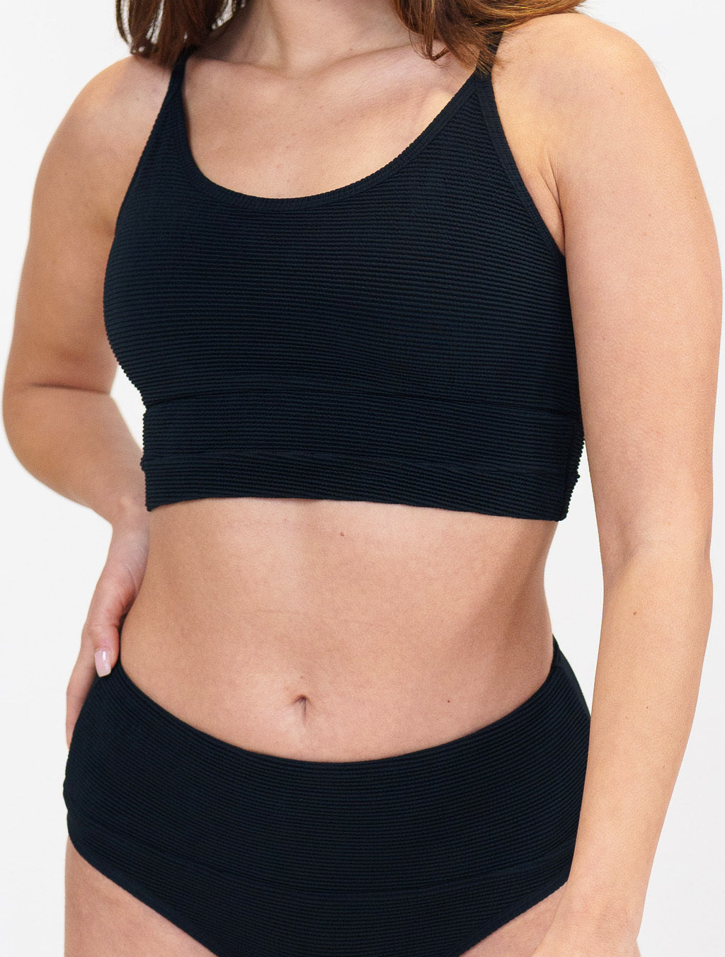 model wearing a black bathing suit