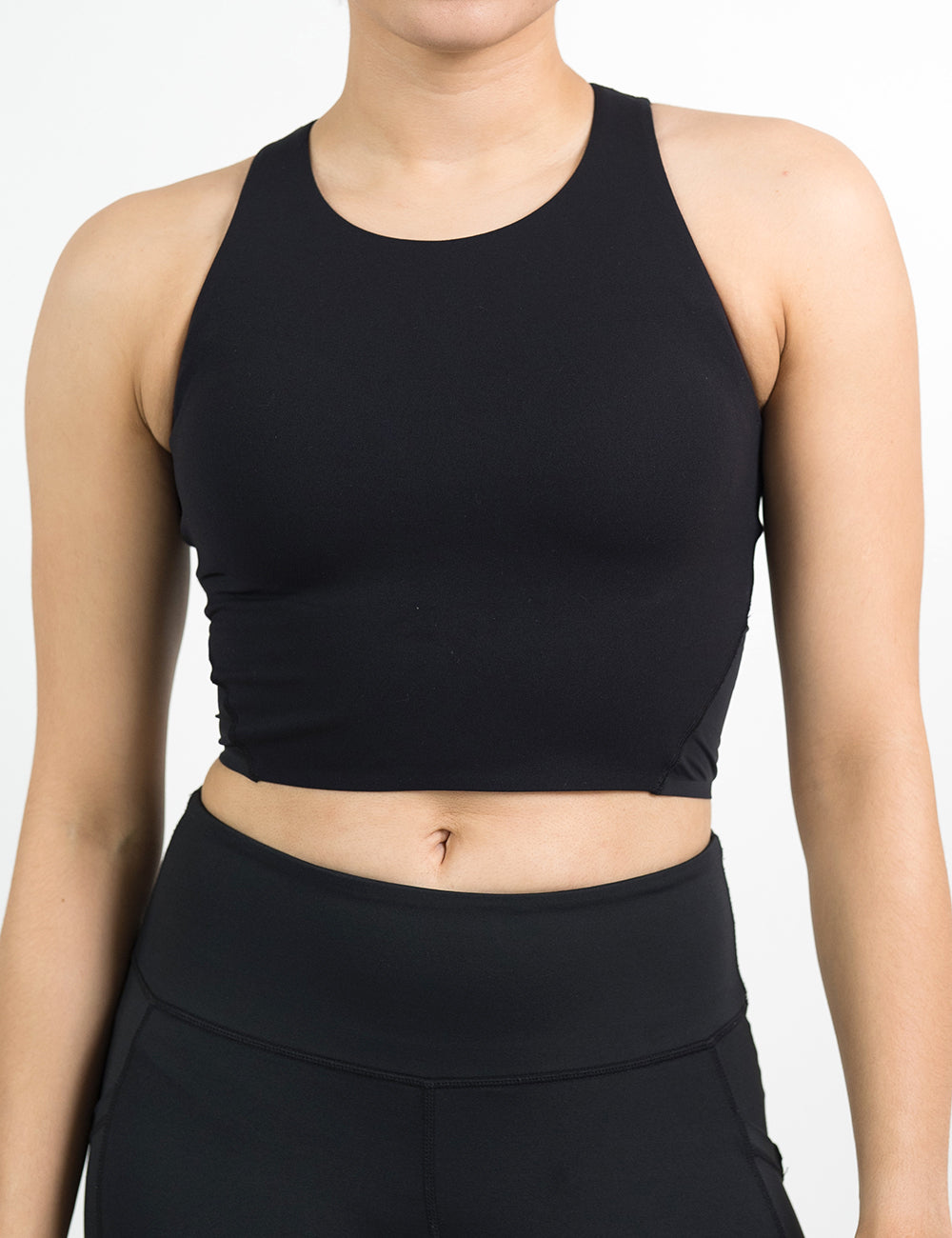 front of the black cropped tank top against a white background