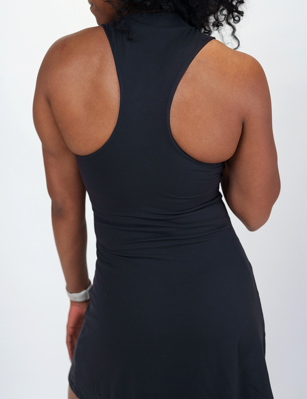 back of the black half zip dress against a white background