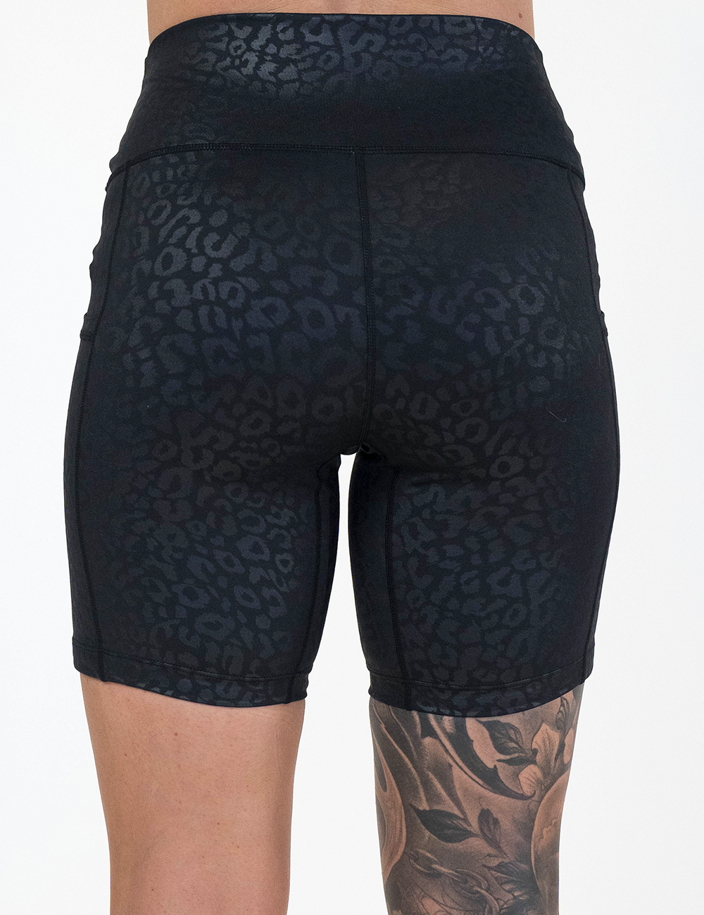 back of the 7 inch black leopard print shorts against a white background