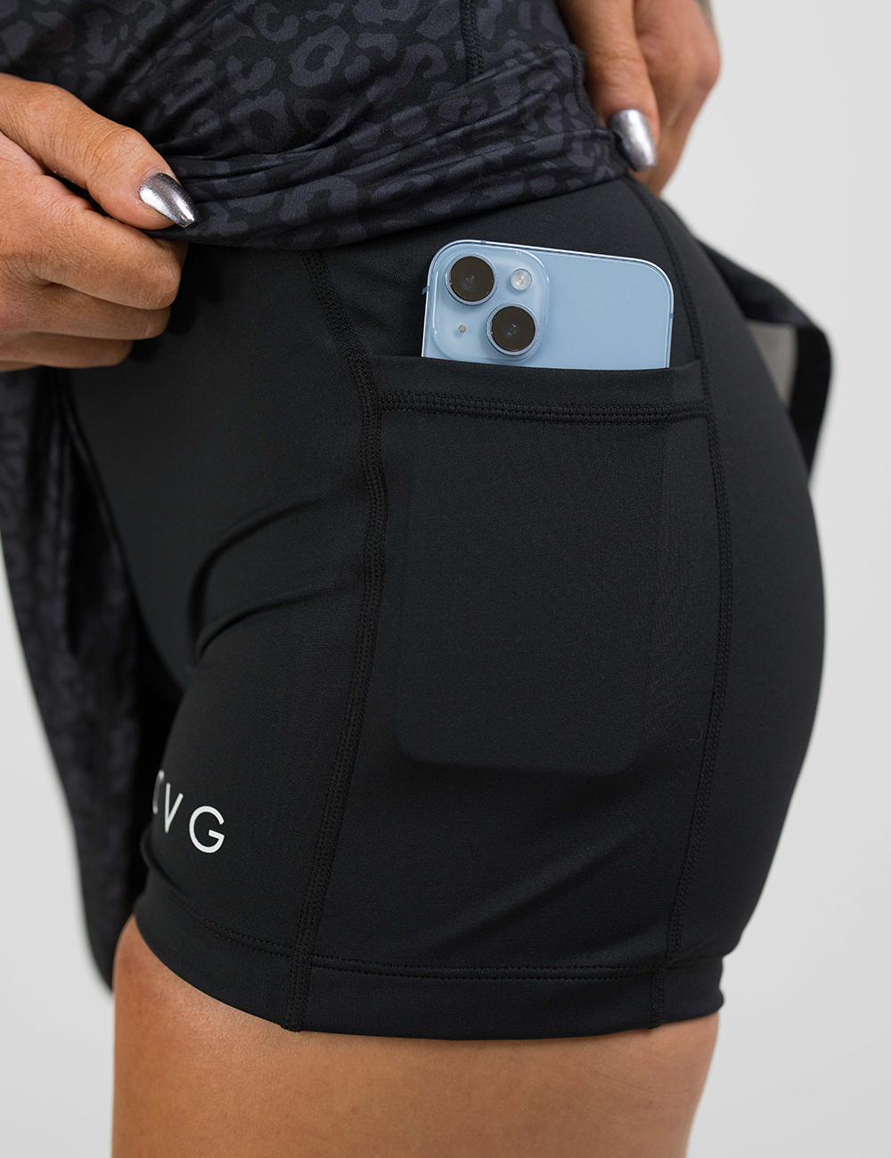 black leopard print dress close up of the shorts underneath with a phone in the pocket