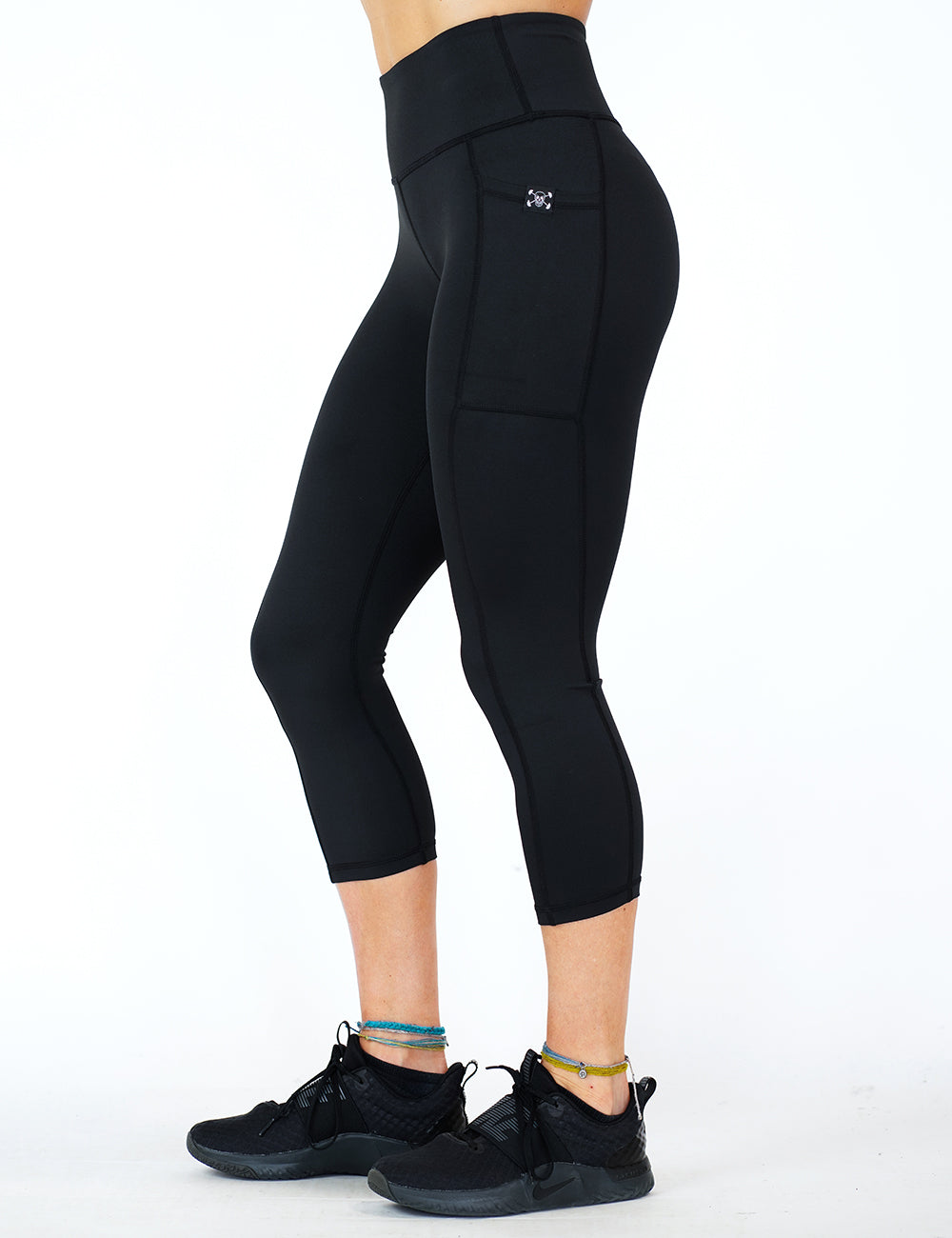 front of the capri solid black leggings against a white background