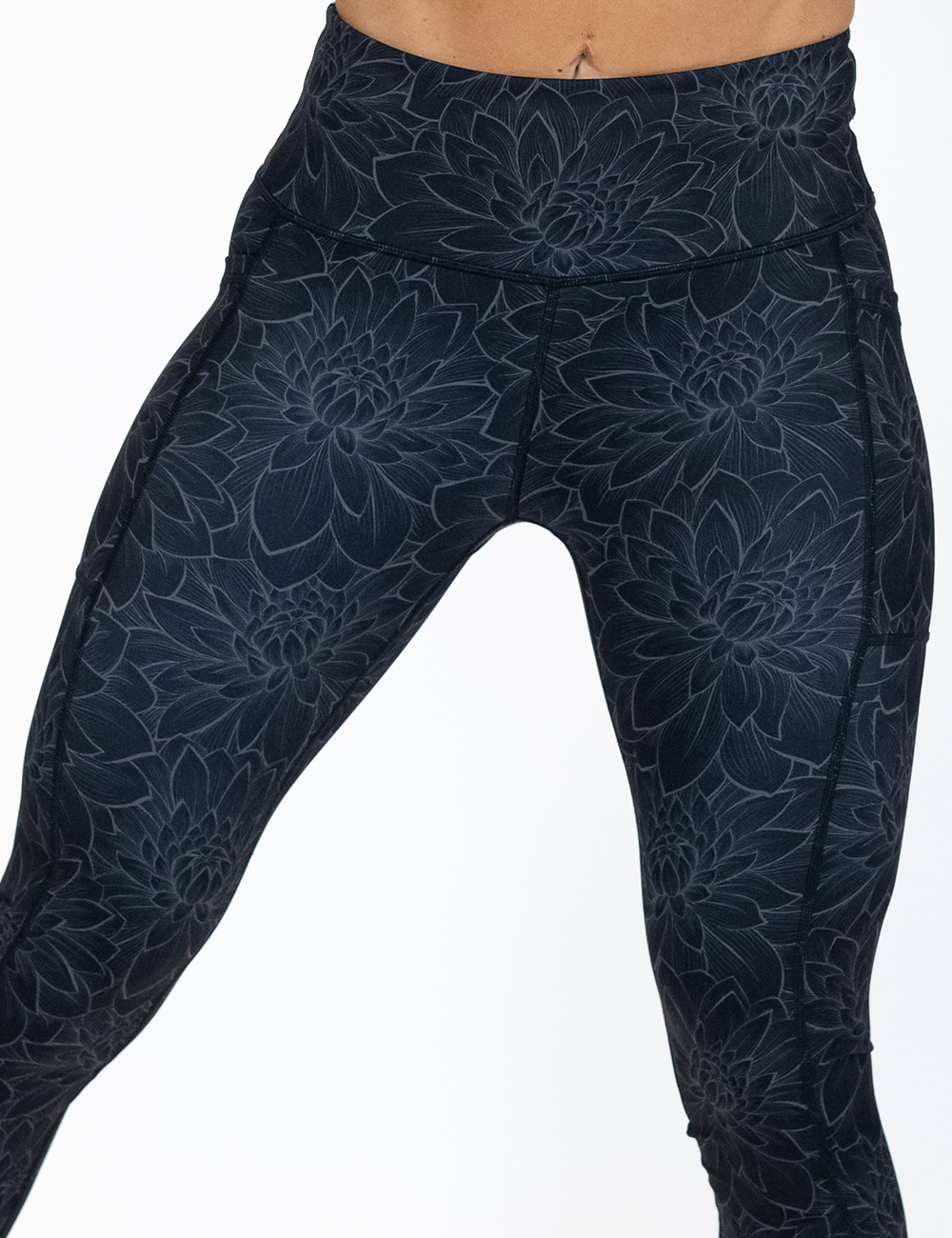 close up of the black lotus flowers  leggings against a white background