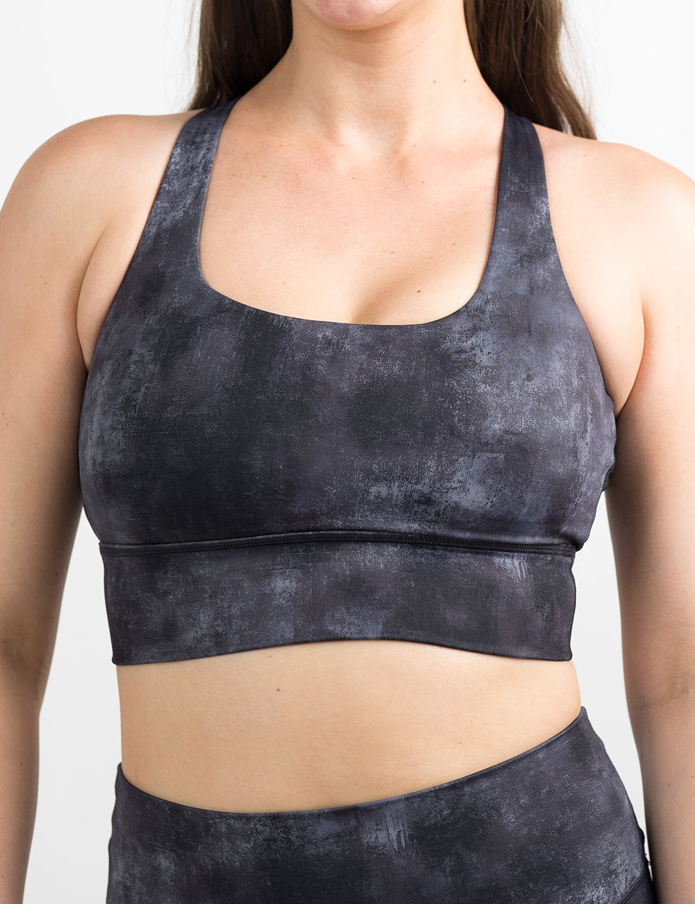 front of the black and grey grunge concrete pattern bra against a white background