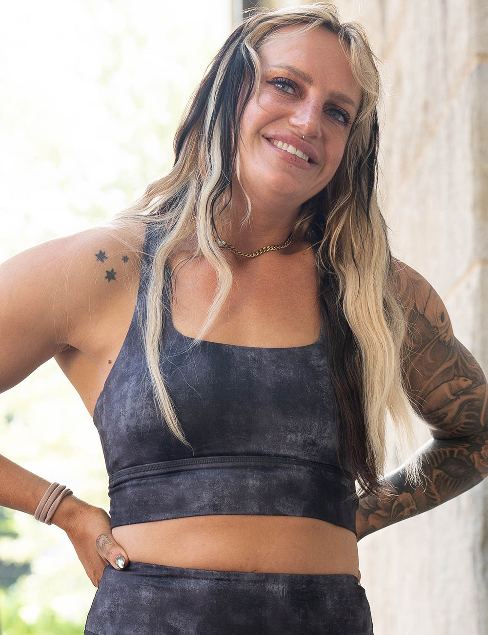 model wearing the black and grey grunge concrete pattern sports bra