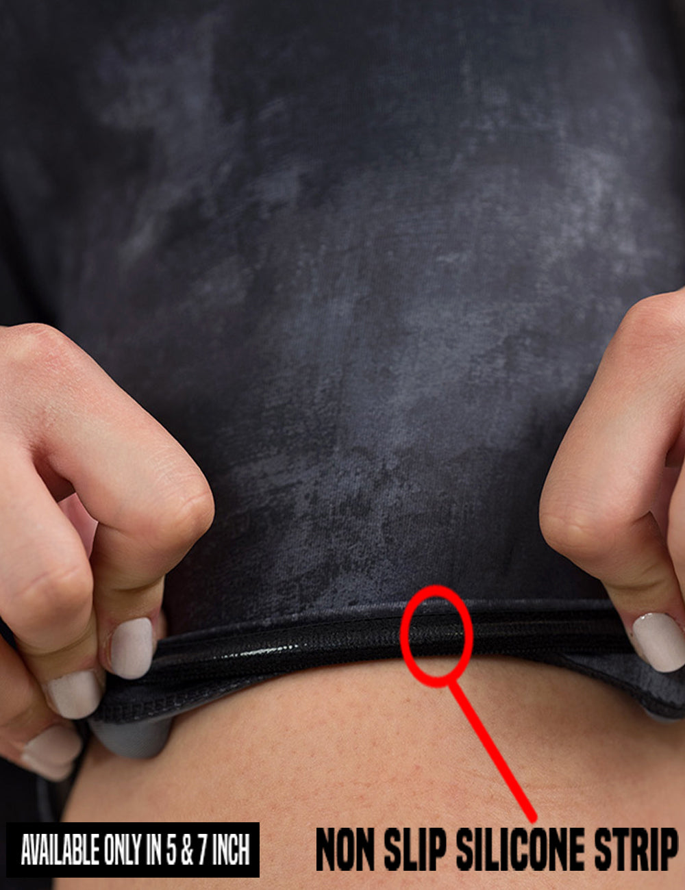 close up of the black and grey grunge concrete pattern shorts being rolled up to show the non slip silicone strip found in the 5 and 7 inch inseam shorts