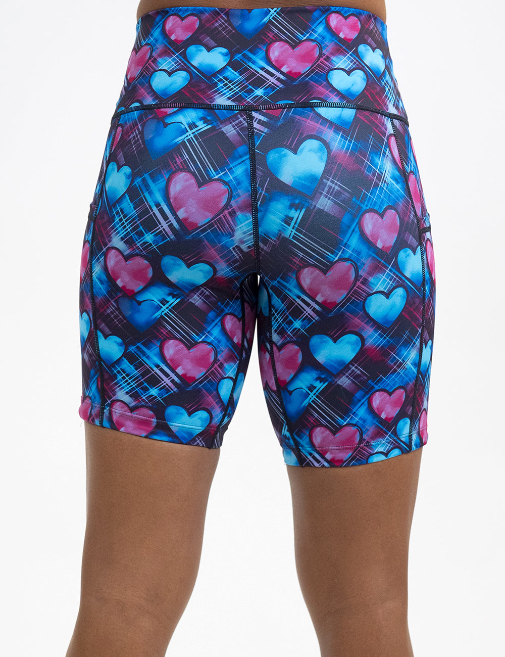 back of the 7 inch blue and pink hearts pattern against a dark stitched background shorts against a white background